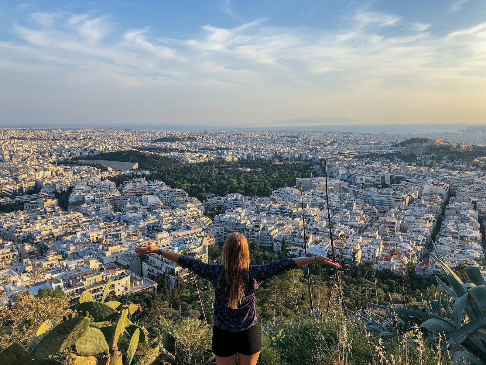 solo female travel safety woman in black long sleeve shirt standing on top of the mountain during daytime